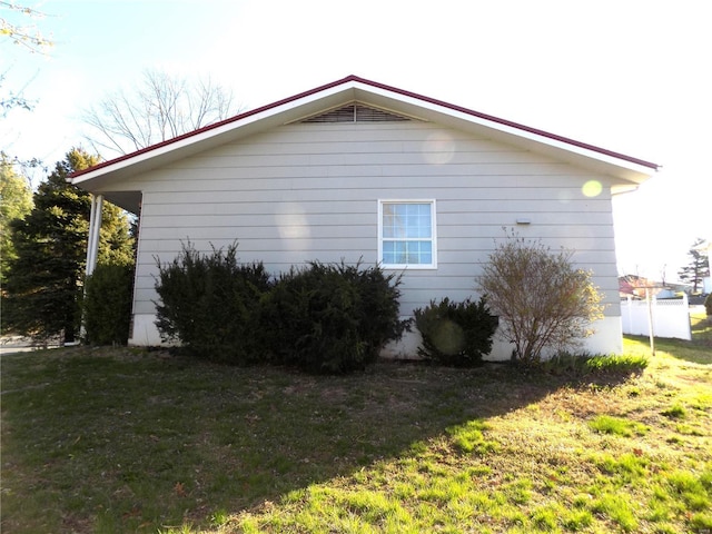 view of side of home featuring a yard