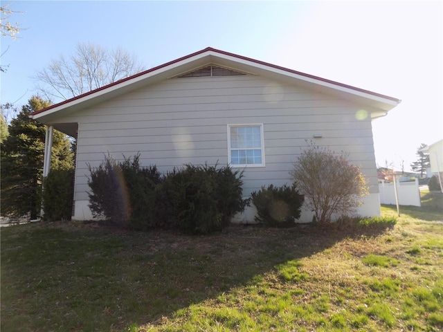 view of property exterior with a yard