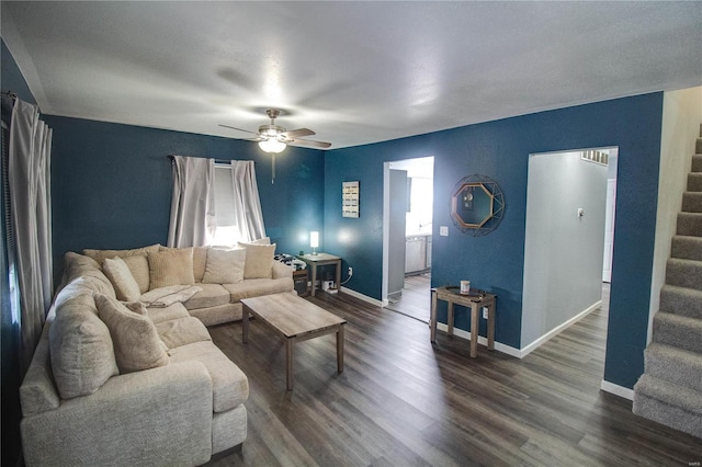 living room with dark wood-type flooring and ceiling fan