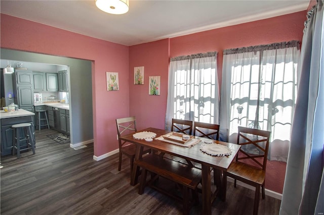 dining space with dark wood-type flooring