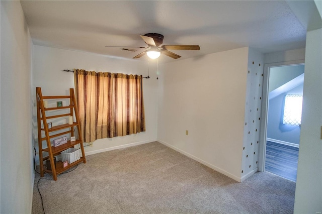 spare room featuring ceiling fan and carpet flooring