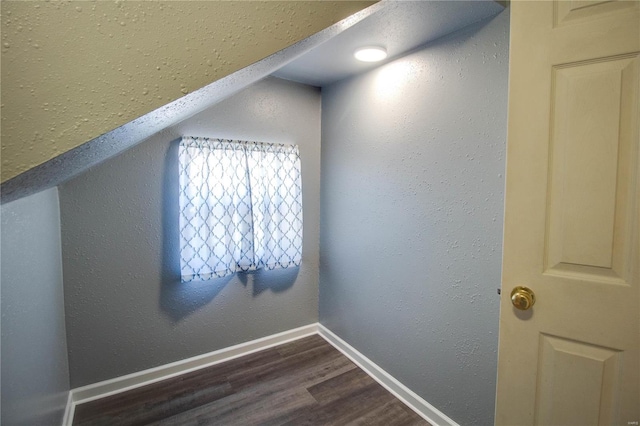 bonus room featuring hardwood / wood-style flooring and lofted ceiling