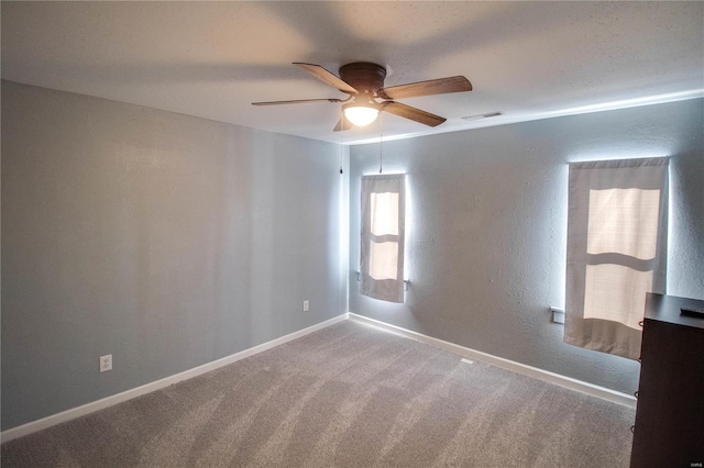 spare room featuring carpet floors and ceiling fan