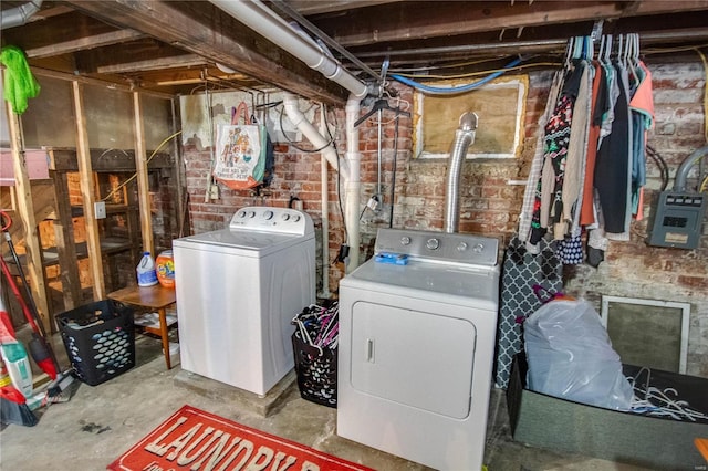 clothes washing area with washing machine and dryer