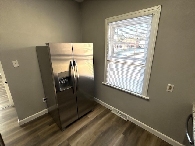 kitchen with stainless steel fridge and dark hardwood / wood-style flooring