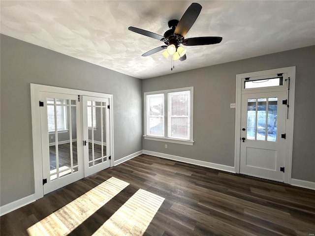 interior space with ceiling fan, dark wood-type flooring, and a wealth of natural light