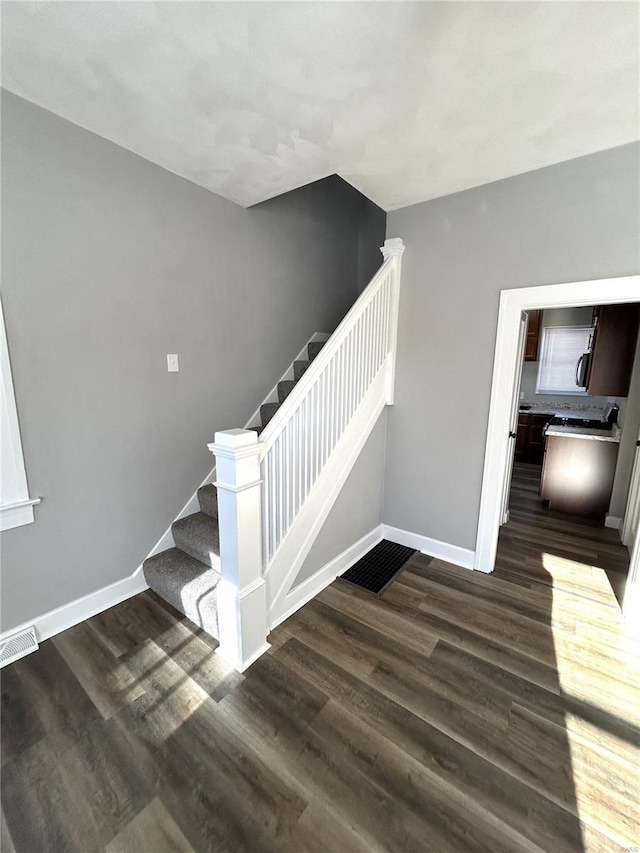 staircase featuring hardwood / wood-style floors