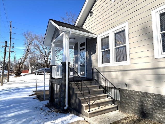 view of snow covered property entrance