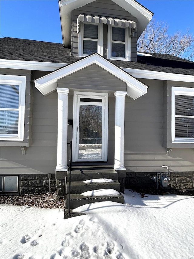 view of snow covered property entrance