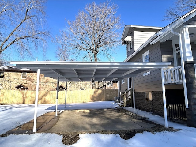 view of snow covered parking area