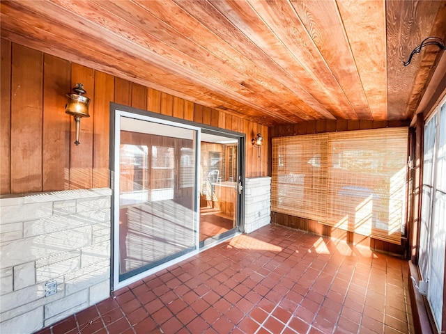 unfurnished sunroom with wood ceiling