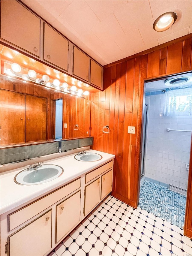 bathroom with vanity, wooden walls, and a shower with door