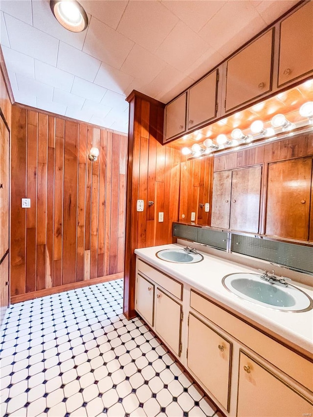 bathroom with vanity and wooden walls