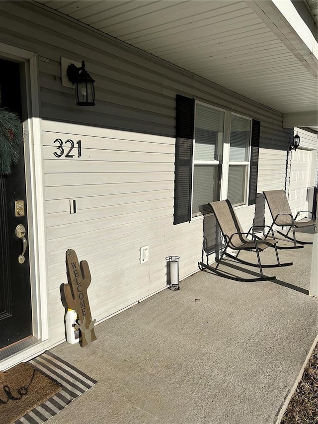 view of patio with a garage and covered porch