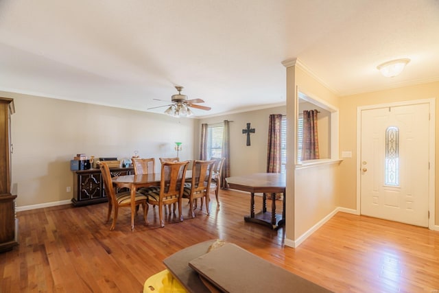 dining space featuring ceiling fan, wood-type flooring, and crown molding