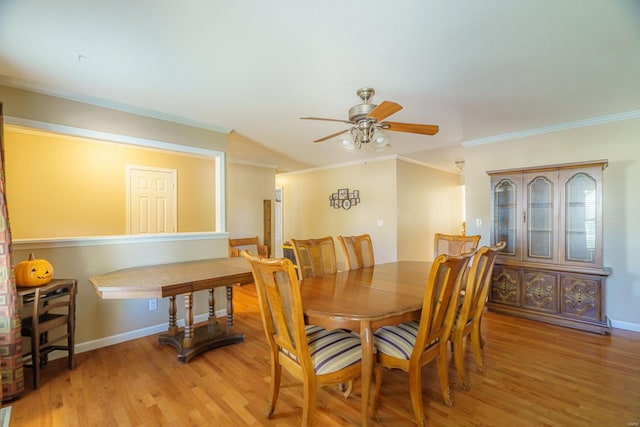 dining space with ceiling fan, light wood-type flooring, and ornamental molding