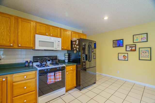 kitchen featuring light tile patterned floors, backsplash, white appliances, and a textured ceiling