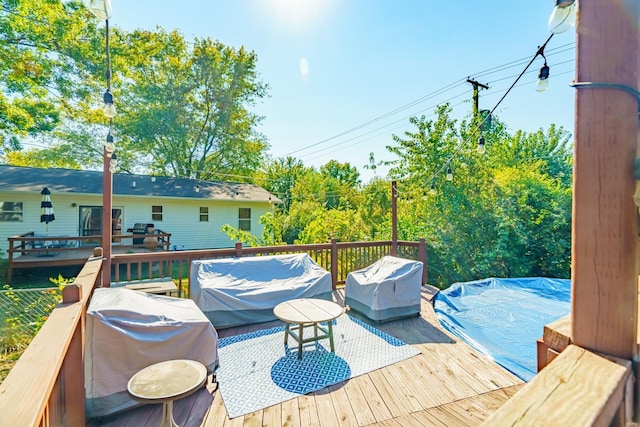 wooden terrace featuring grilling area