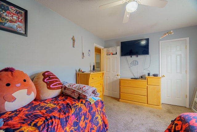 bedroom with ceiling fan and light carpet