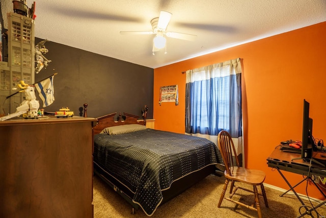 bedroom featuring a textured ceiling, ceiling fan, and carpet flooring