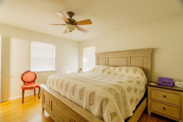 bedroom with ceiling fan and hardwood / wood-style flooring