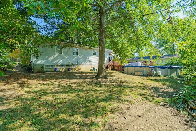 view of yard featuring a covered pool