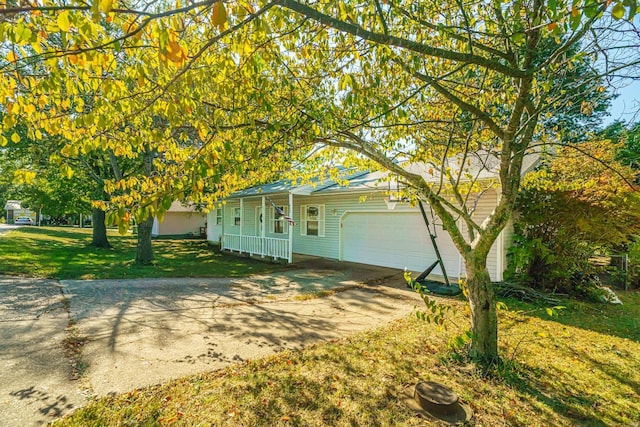 view of front of house with a garage, a front yard, and a porch