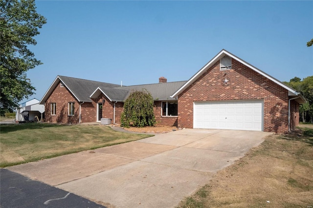 view of front of house with a garage and a front yard