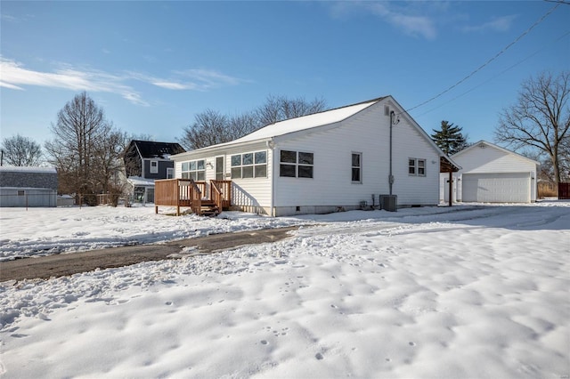 exterior space with an outbuilding, cooling unit, a deck, and a garage