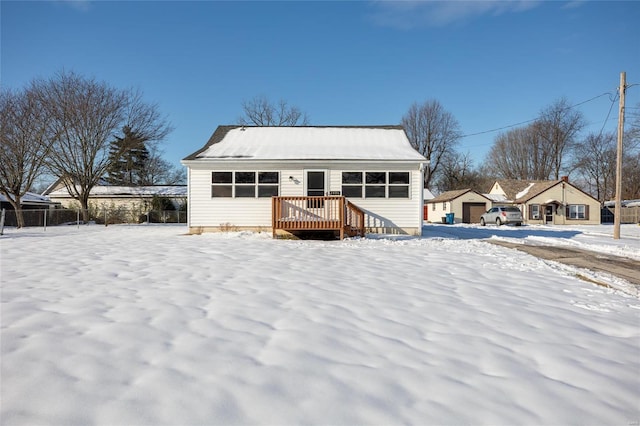 snow covered property with a wooden deck