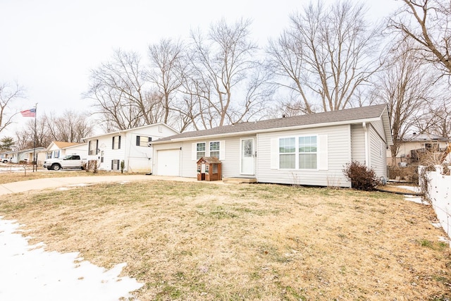 view of front of house with a garage and a front lawn