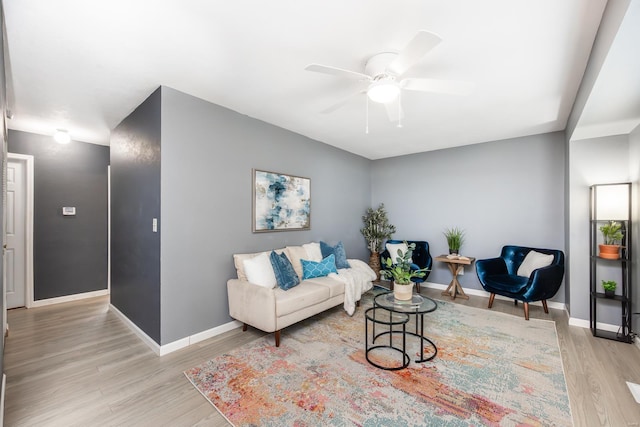 living room featuring ceiling fan and light hardwood / wood-style flooring