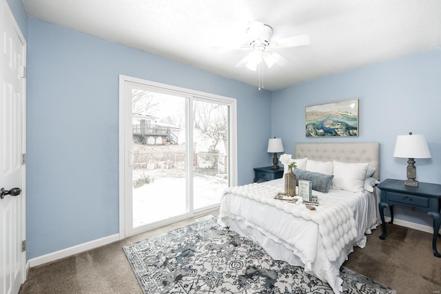 bedroom featuring multiple windows, dark colored carpet, access to outside, and ceiling fan