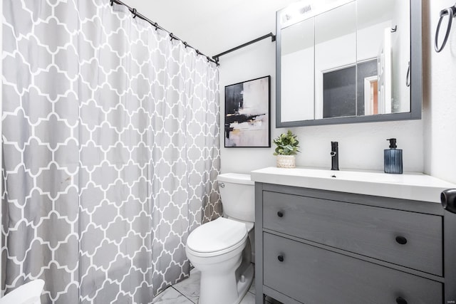 bathroom featuring vanity, toilet, and walk in shower