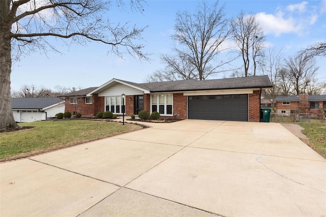 ranch-style home with a garage and a front lawn