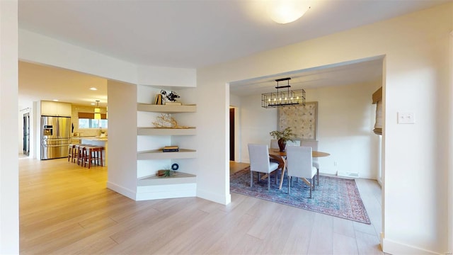 interior space with a chandelier and light wood-type flooring