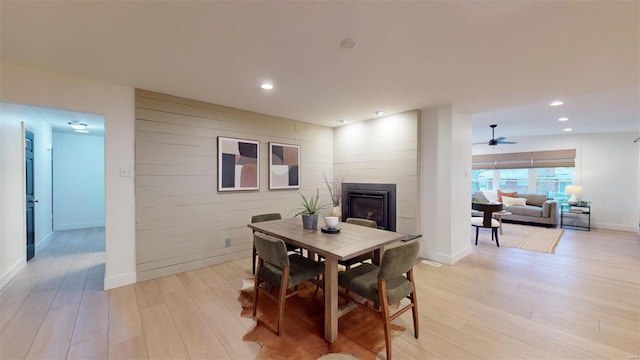 dining area with ceiling fan and light hardwood / wood-style floors