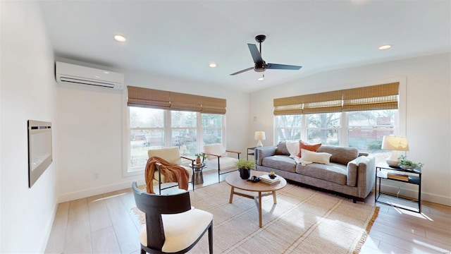 living room featuring plenty of natural light, light hardwood / wood-style flooring, and an AC wall unit