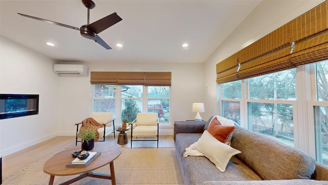 living room with ceiling fan, lofted ceiling, a wall unit AC, and light hardwood / wood-style flooring