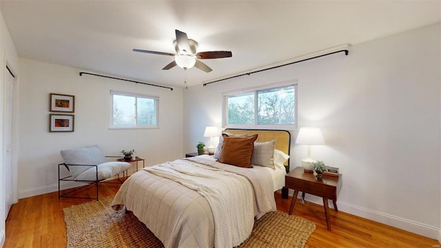 bedroom featuring ceiling fan, a closet, and light wood-type flooring