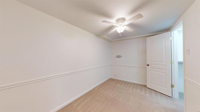 carpeted spare room featuring ceiling fan