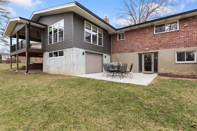 back of property featuring a yard and a patio