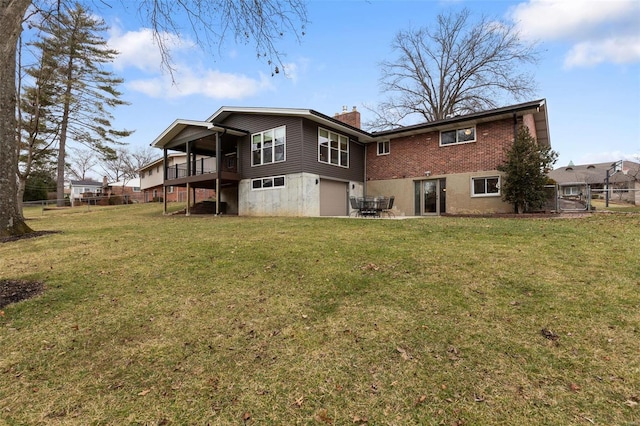 back of property with a lawn and a deck