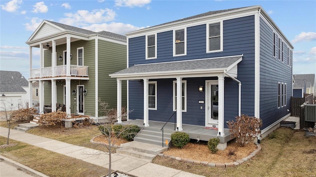 view of front of home with a porch and roof with shingles