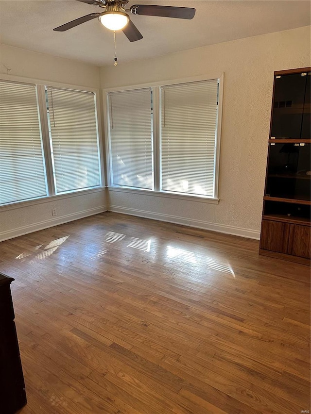 unfurnished room featuring ceiling fan and wood-type flooring