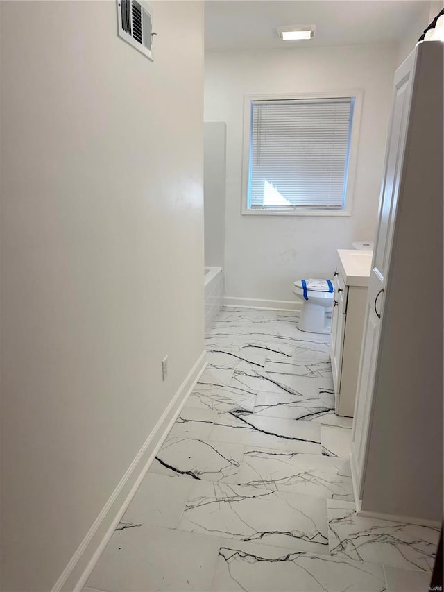 bathroom featuring toilet and vanity