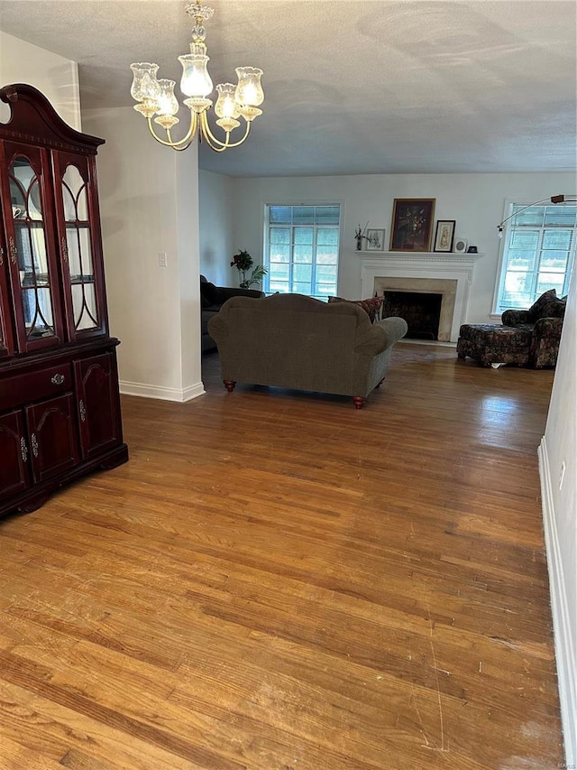 living room with wood-type flooring and an inviting chandelier