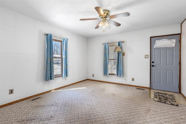 carpeted foyer entrance with ceiling fan