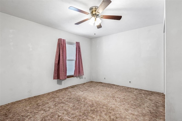 empty room with ceiling fan and carpet