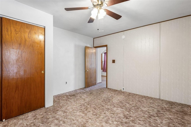 unfurnished bedroom with ceiling fan and light colored carpet